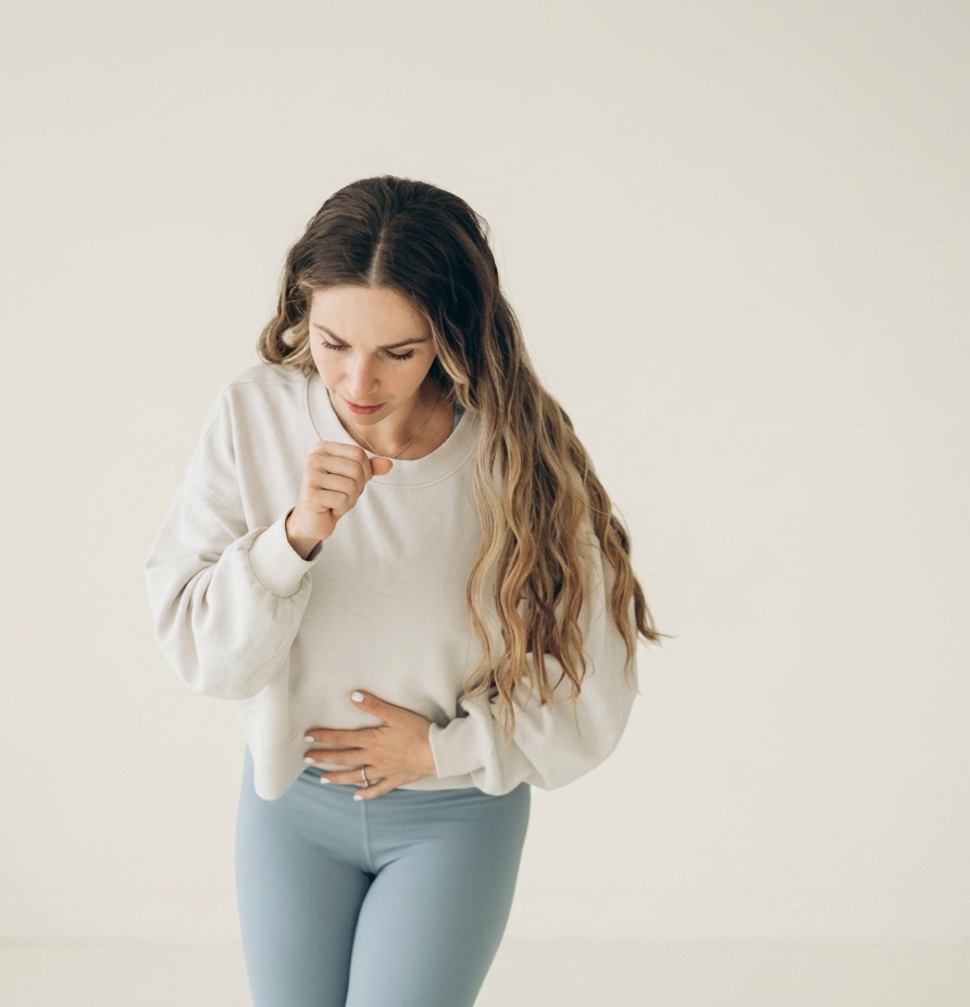 a-woman-experiencing-stress-urinary-leakage-while-coughing